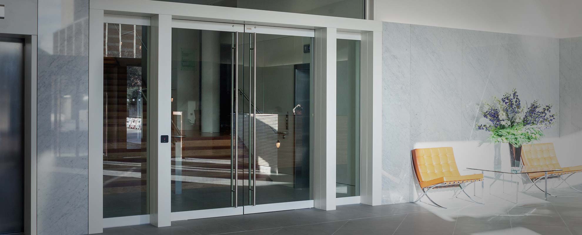 Glass commercial door with tall chrome handles
